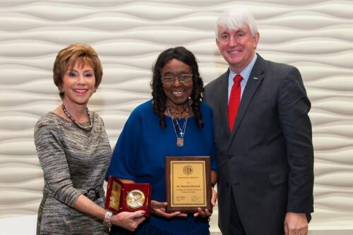 Mitchell Receiving Professor Emeritus Award from President and Provost