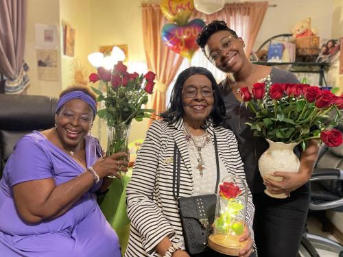 Dr.-Mitchell-with-daughter-Marcia-on-one-side-and-granddaughter-Jamila-on-right-holding-bunch-of-roses-for-celebration-of-birthday-2021